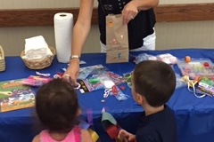 ecec director Sheryl W giving treats to kids